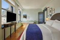 a bedroom with a bed and a tub and a television at Hotel Per La, Autograph Collection in Los Angeles