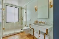 a bathroom with a toilet and a sink and a shower at Hotel Per La, Autograph Collection in Los Angeles