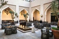 a lobby with tables and chairs in a building at The Heritage Hotel, Autograph Collection, Downtown Dubai in Dubai
