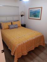 ein Schlafzimmer mit einem Bett und einem Kissen darauf in der Unterkunft Shore Tails, LLC in Myrtle Beach