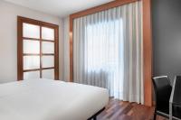 A bed or beds in a room at AC Hotel Ponferrada by Marriott