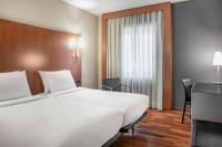 A bed or beds in a room at AC Hotel Ponferrada by Marriott