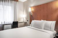 A bed or beds in a room at AC Hotel Ponferrada by Marriott
