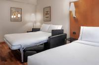 A bed or beds in a room at AC Hotel Ponferrada by Marriott