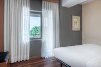 A bed or beds in a room at AC Hotel Ponferrada by Marriott