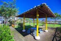 a gazebo with a roof in a park at Chun Feng Cao Tang Homestay in Yuanshan