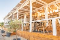 a building with chairs and tables on a patio at Green Line Villa Sozopol in Sozopol