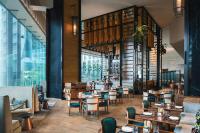 um restaurante com mesas, cadeiras e janelas em Renaissance Hong Kong Harbour View Hotel em Hong Kong