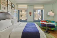 a bedroom with a large bed and a chair at Hotel Per La, Autograph Collection in Los Angeles