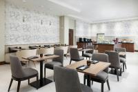 a restaurant with tables and chairs and a kitchen at AC Hotel by Marriott Honolulu in Honolulu