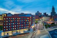 a city skyline at night with a red building at Aloft Providence Downtown in Providence