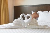 Postel nebo postele na pokoji v ubytování Rhienchai Place Hotel