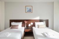 Postel nebo postele na pokoji v ubytování Rhienchai Place Hotel