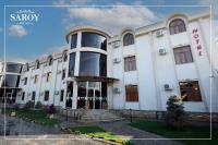 Un gran edificio blanco con escaleras al frente. en Hotel Saroy palace in Qarshi city, en Qarshi