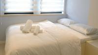 a white bed with two towels on top of it at Rodax Residence in Istanbul