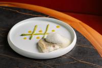 a white plate with some food on a table at Hotel Royal Victoria, by R Collection Hotels in Varenna