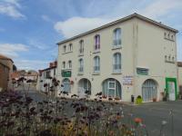 a large white building on the side of a street at Résidence L&#39;Ogomé in Le Boupère