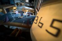 a table with a blue table cloth and wine glasses at Fenyves Yacht Club Superior in Balatonfenyves