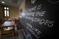 a chalkboard with writing on a wall in a restaurant at Fenyves Yacht Club Superior in Balatonfenyves