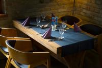 a table with a blue table cloth and wine glasses at Fenyves Yacht Club Superior in Balatonfenyves