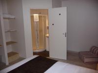 a room with a bed and a door to a bathroom at La Godinière in Cholet