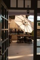 een patio met een tafel en een witte parasol bij Casa Bonita Hotel & Luxury Residence in Oaxaca City