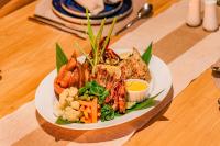 een bord met vis en groenten op een tafel bij The Coast Sri Lanka, Bentota in Bentota