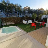 a backyard with a hot tub and chairs and a table at Lagos Charming Villas in Lagos