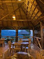 a wooden table and chairs on a wooden deck at Nyanja View Resort in Fort Portal