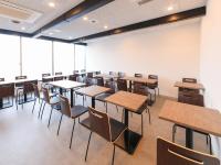 an empty lecture room with tables and chairs at APA Hotel Hakodate Ekimae in Hakodate