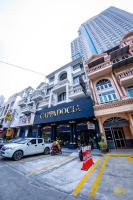 a building with a car parked in front of it at Kiwi Capsule Hotel in Bangkok