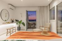 A bed or beds in a room at Seanfinity Beachfront Suites