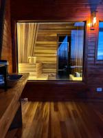 a bathroom with a large window and a sink at Chalé Boutique Spa- Sauna seca, Jacuzzi , Rede suspensa in Campos do Jordão
