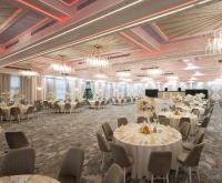 a banquet hall with tables and chairs and chandeliers at CHITULESCU Hotel in Târgovişte