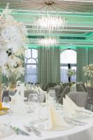 a dining room with white tables and chairs and a chandelier at CHITULESCU Hotel in Târgovişte