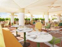a restaurant with white tables and chairs and chairs at Don Carlos Marbella in Marbella