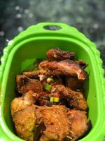 a green bowl of food with meat in it at Korbekwan Homestay in Besir