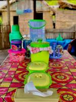 a table topped with green containers on top of a table at Korbekwan Homestay in Besir