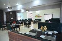 a dining room with tables and chairs and a chalkboard at Hotel Shri Kailash Mansarovar in Sāgar