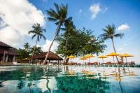 a swimming pool with chairs and umbrellas and trees at PingChan Koh Phangan Beachfront Resort in Thong Nai Pan Yai