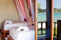 two beds in a room with a view of the ocean at PingChan Koh Phangan Beachfront Resort in Thong Nai Pan Yai