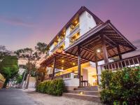 a white house with a wooden roof at Rendezvous Classic House in Chiang Mai