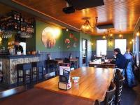 un bar avec une table en bois dans un restaurant dans l'établissement glamping met landelijk uitzicht, à Spanga