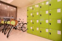 a room with green lockers and bikes in it at Kiwi Express Hotel - Zhong Zheng Branch in Taichung