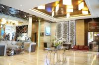 a lobby with couches and tables in a building at Treppan Hotel & Suites By Fakhruddin in Dubai