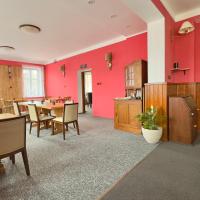 comedor con mesa y pared roja en Hotel Zelený dům, en Dolní Poustevna