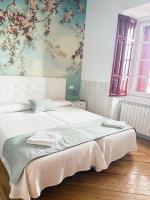 Postel nebo postele na pokoji v ubytování Casa Jardín El Colmenar