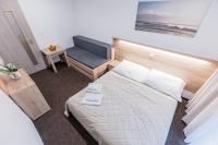 A bed or beds in a room at Hotel Hrabovo