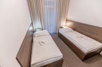 A bed or beds in a room at Hotel Hrabovo