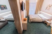 A bed or beds in a room at Hotel Hrabovo